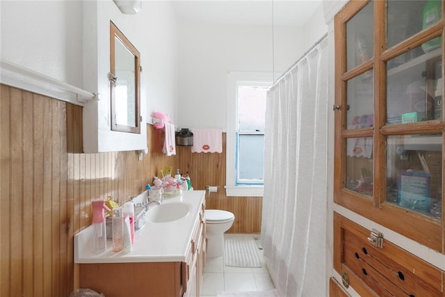 5655 Hawthorne Pl, New Orleans, LA 70124 - bathroom with toilet, vanity, a wainscoted wall, tile patterned floors, and wooden walls
