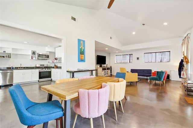 8621 Cohn St, New Orleans, LA 70118 - dining space with high vaulted ceiling, finished concrete flooring, recessed lighting, and a ceiling fan