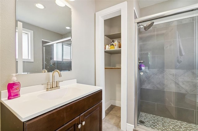 8621 Cohn St, New Orleans, LA 70118 - full bath with vanity, a stall shower, a spacious closet, tile patterned flooring, and recessed lighting