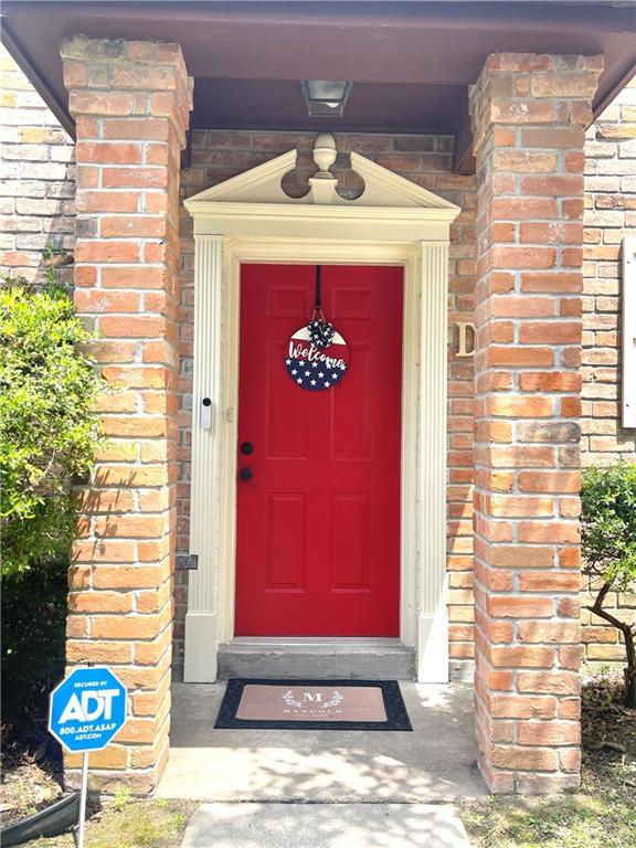 29 Brandon Hall Dr Unit D, Destrehan, LA 70047 - view of exterior entry featuring brick siding
