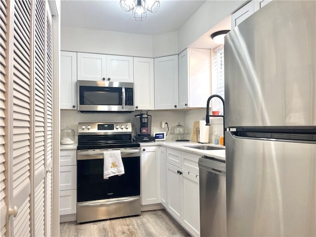 29 Brandon Hall Dr Unit D, Destrehan, LA 70047 - kitchen featuring appliances with stainless steel finishes, a sink, light countertops, and white cabinetry