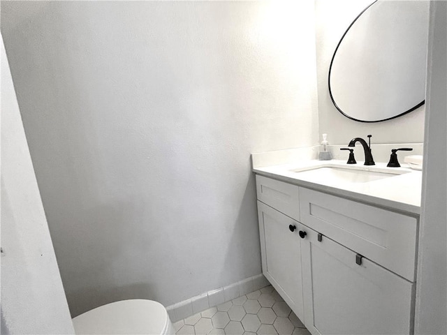 29 Brandon Hall Dr Unit D, Destrehan, LA 70047 - half bathroom featuring vanity, toilet, tile patterned flooring, and baseboards