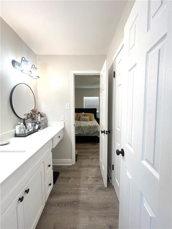 29 Brandon Hall Dr Unit D, Destrehan, LA 70047 - bathroom with vanity, wood finished floors, baseboards, and ensuite bath