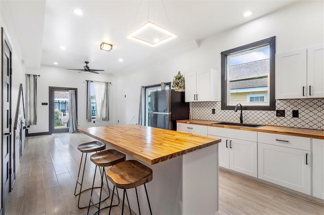 5400 N Rampart St, New Orleans, LA 70117 - kitchen featuring wooden counters, freestanding refrigerator, a sink, plenty of natural light, and recessed lighting