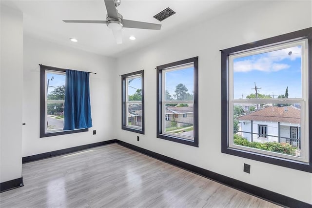 5400 N Rampart St, New Orleans, LA 70117 - empty room featuring plenty of natural light, a ceiling fan, recessed lighting, wood finished floors, and baseboards