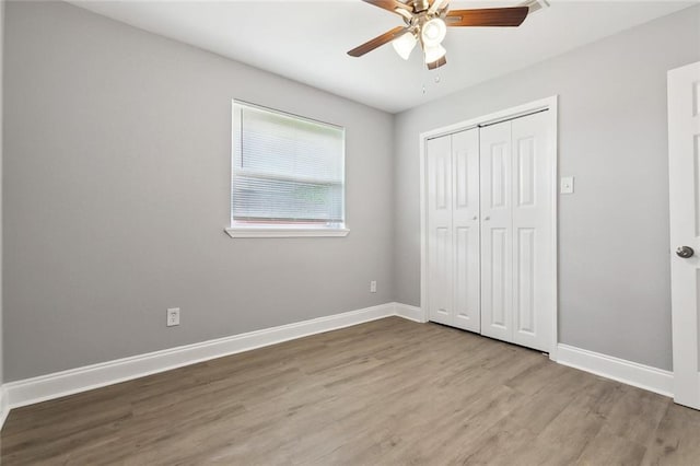 7500 Primrose Dr, New Orleans, LA 70126 - unfurnished bedroom with wood finished floors, baseboards, a closet, and a ceiling fan