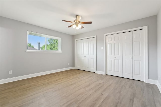 7500 Primrose Dr, New Orleans, LA 70126 - unfurnished bedroom with multiple closets, baseboards, light wood-type flooring, and ceiling fan