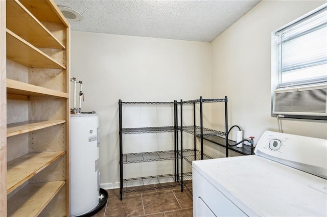 2308 Lloyds Ave, Chalmette, LA 70043 - laundry room with washer / dryer, electric water heater, a textured ceiling, and dark tile patterned flooring