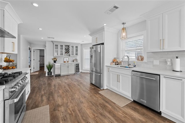 3508 Main St, La Place, LA 70068 - kitchen featuring premium appliances, a sink, decorative backsplash, white cabinetry, and light countertops