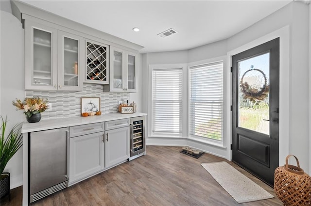 3508 Main St, La Place, LA 70068 - entrance foyer with wine cooler, a dry bar, wood finished floors, recessed lighting, and baseboards