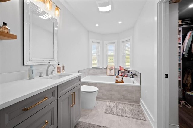 3508 Main St, La Place, LA 70068 - bathroom with a bath, vanity, a walk in closet, toilet, and recessed lighting