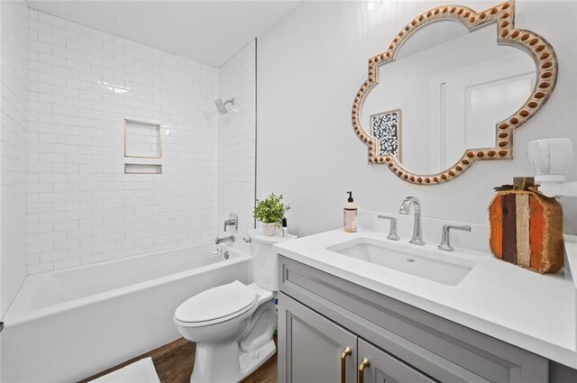 3508 Main St, La Place, LA 70068 - full bathroom featuring vanity, toilet,  shower combination, and wood finished floors