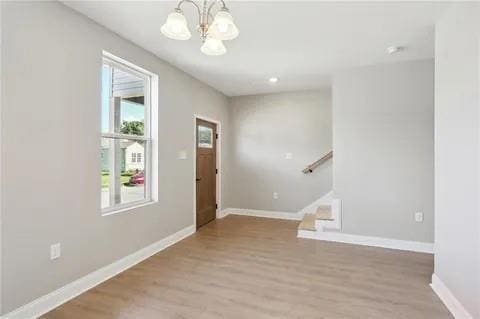 4021 N Rocheblave St, New Orleans, LA 70117 - foyer featuring a chandelier, wood finished floors, stairway, and baseboards