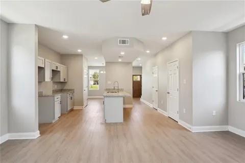 4021 N Rocheblave St, New Orleans, LA 70117 - kitchen with light wood-type flooring, baseboards, light countertops, and recessed lighting