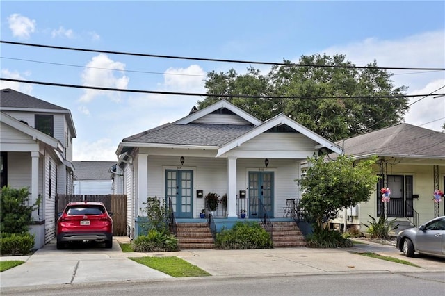 304 Henry Clay Ave, New Orleans, LA 70118 - view of front of house featuring a porch, french doors, and a shingled roof
