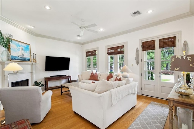 228 Shady Pond Ln, Covington, LA 70435 - living room with crown molding, ceiling fan, recessed lighting, a fireplace, and light wood-type flooring