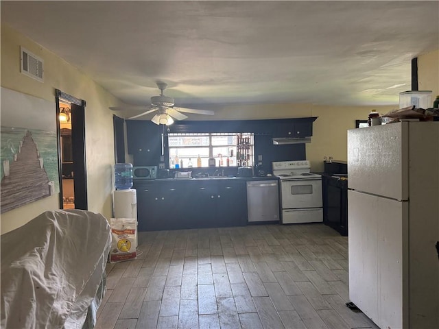 5022 Mcmurtry St, Marrero, LA 70072 - kitchen featuring white appliances, wood finished floors, ceiling fan, and under cabinet range hood