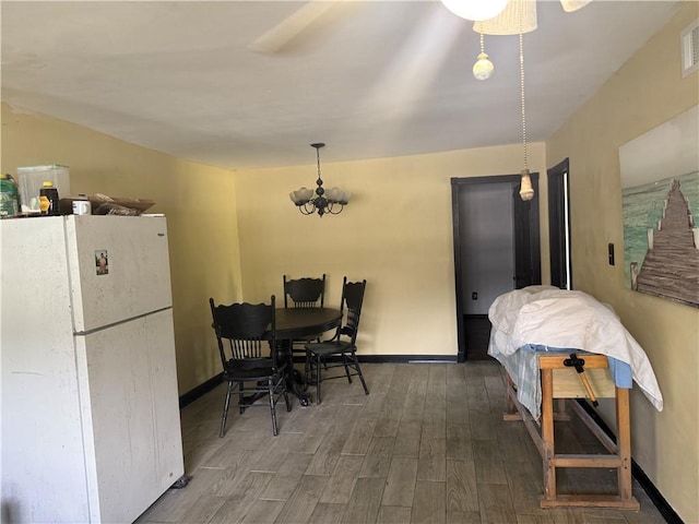 5022 Mcmurtry St, Marrero, LA 70072 - dining area with wood finished floors, baseboards, and a chandelier