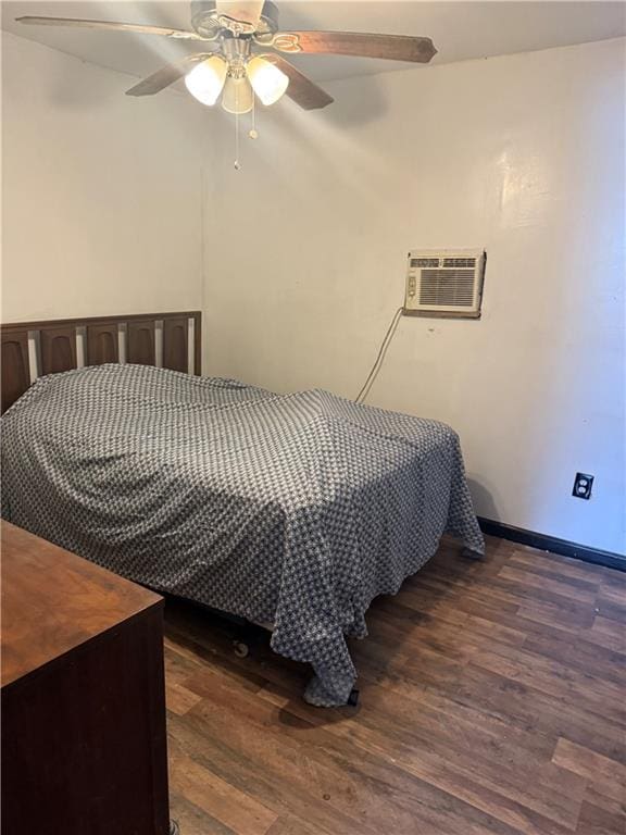 5022 Mcmurtry St, Marrero, LA 70072 - bedroom featuring a wall unit AC, dark wood finished floors, baseboards, and a ceiling fan