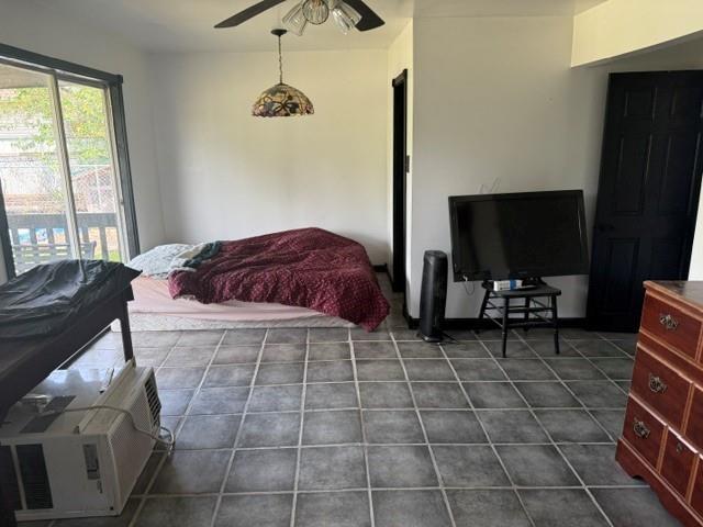 5022 Mcmurtry St, Marrero, LA 70072 - bedroom featuring dark tile patterned flooring and a ceiling fan