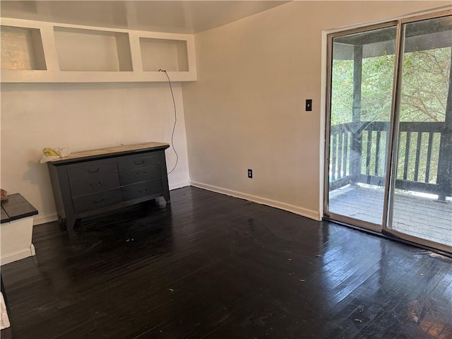 5022 Mcmurtry St, Marrero, LA 70072 - unfurnished living room with baseboards and dark wood-type flooring