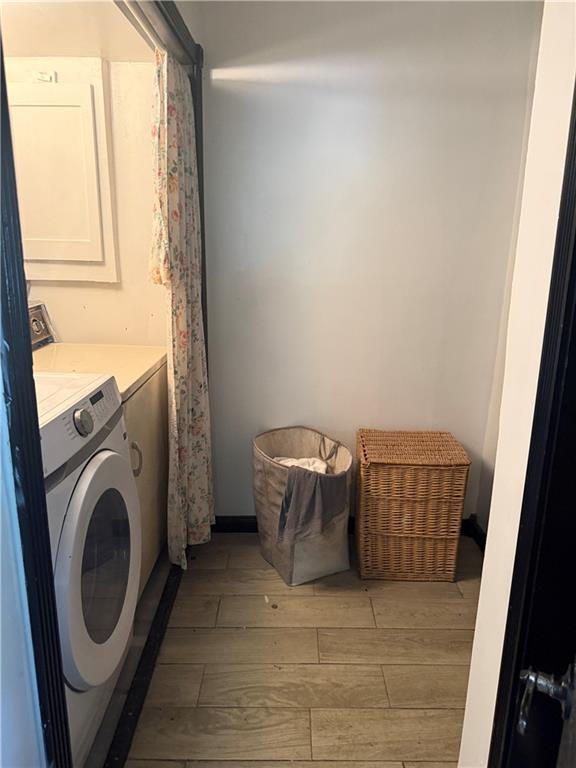 5022 Mcmurtry St, Marrero, LA 70072 - laundry room featuring light wood-type flooring and separate washer and dryer