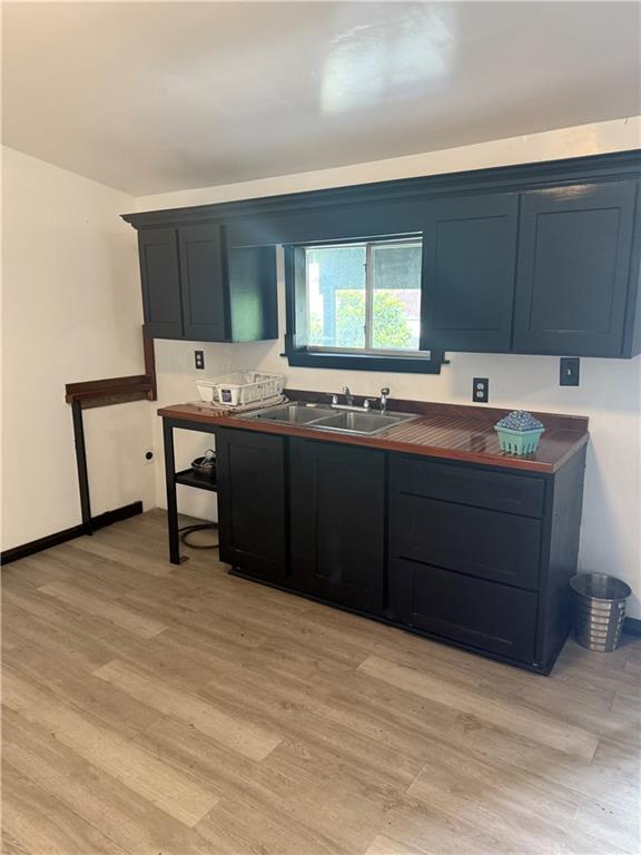 5022 Mcmurtry St, Marrero, LA 70072 - kitchen featuring a sink and light wood-style floors