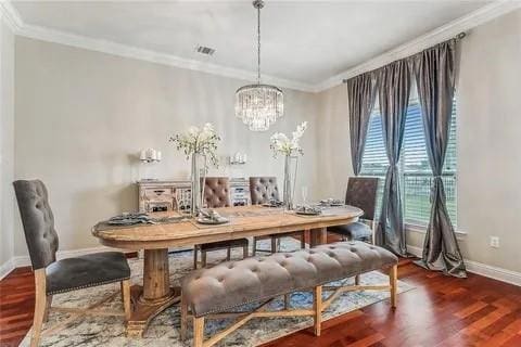 298 Saw Grass Loop, Covington, LA 70435 - dining space featuring baseboards, wood finished floors, ornamental molding, and a chandelier