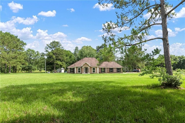 15488 Lake Ramsey Rd, Covington, LA 70435 - view of front facade with a front yard and view of wooded area