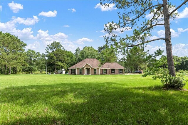 15488 Lake Ramsey Rd, Covington, LA 70435 - view of front facade with a front lawn and view of scattered trees