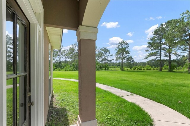 15488 Lake Ramsey Rd, Covington, LA 70435 - view of green lawn with view of wooded area