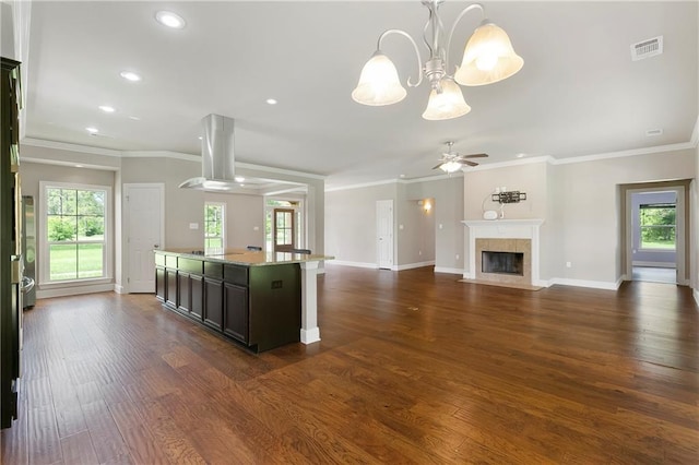 15488 Lake Ramsey Rd, Covington, LA 70435 - kitchen with island exhaust hood, baseboards, recessed lighting, dark wood-type flooring, and ornamental molding