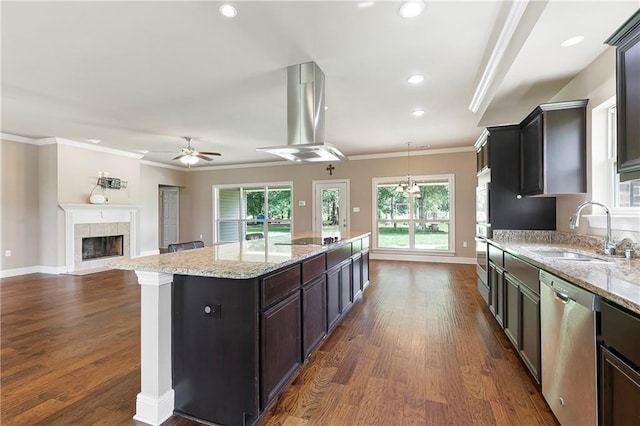 15488 Lake Ramsey Rd, Covington, LA 70435 - kitchen with appliances with stainless steel finishes, a sink, ceiling fan, dark wood finished floors, and a tiled fireplace