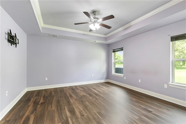15488 Lake Ramsey Rd, Covington, LA 70435 - unfurnished room with crown molding, a raised ceiling, plenty of natural light, and dark wood-style flooring