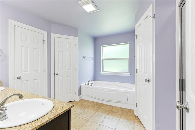 15488 Lake Ramsey Rd, Covington, LA 70435 - bathroom with a closet, a bath, double vanity, tile patterned floors, and baseboards