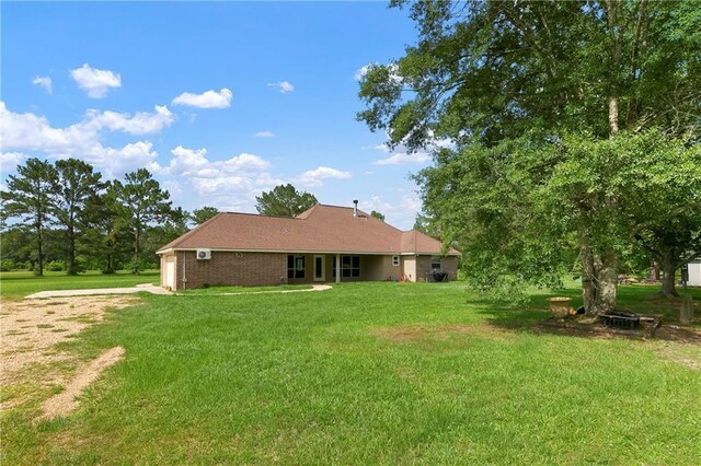 15488 Lake Ramsey Rd, Covington, LA 70435 - rear view of property featuring a yard, driveway, and an attached garage