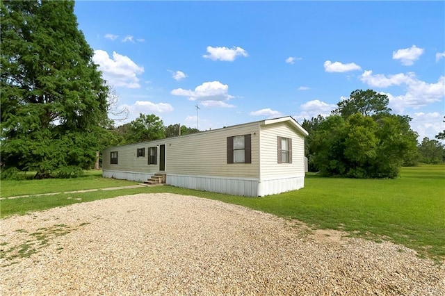 15488 Lake Ramsey Rd, Covington, LA 70435 - view of front of home with entry steps, a front yard, and driveway