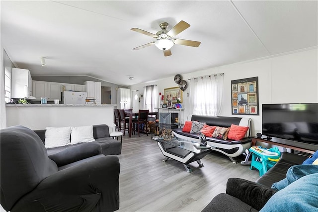 15488 Lake Ramsey Rd, Covington, LA 70435 - living area featuring a ceiling fan, light wood-style floors, and vaulted ceiling