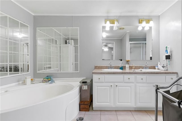 15488 Lake Ramsey Rd, Covington, LA 70435 - bathroom featuring double vanity, a garden tub, tile patterned flooring, ceiling fan, and ornamental molding