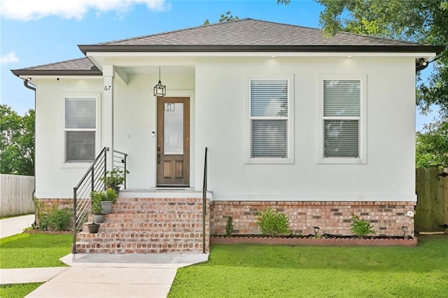 67 W Claiborne Sq, Chalmette, LA 70043 - view of front of house with roof with shingles and brick siding