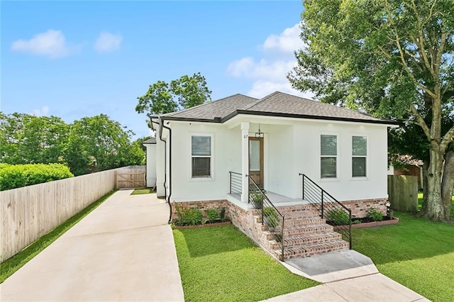 67 W Claiborne Sq, Chalmette, LA 70043 - view of front of home featuring a shingled roof, concrete driveway, stucco siding, and brick siding