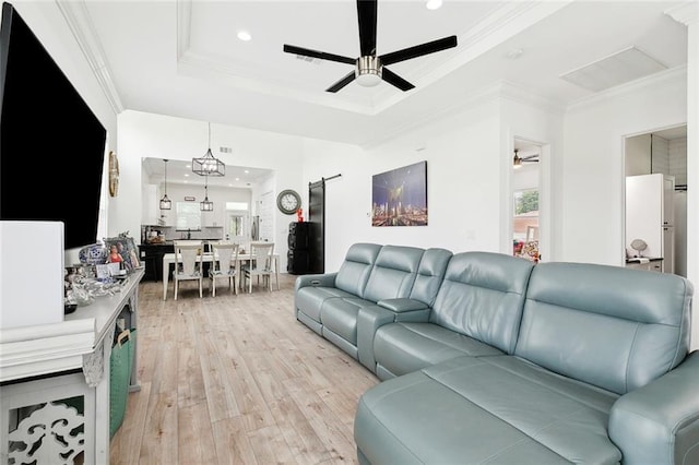 67 W Claiborne Sq, Chalmette, LA 70043 - living area featuring ceiling fan, a tray ceiling, light wood finished floors, healthy amount of natural light, and crown molding