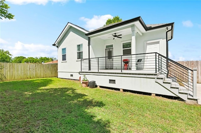 67 W Claiborne Sq, Chalmette, LA 70043 - back of house with a ceiling fan and stucco siding