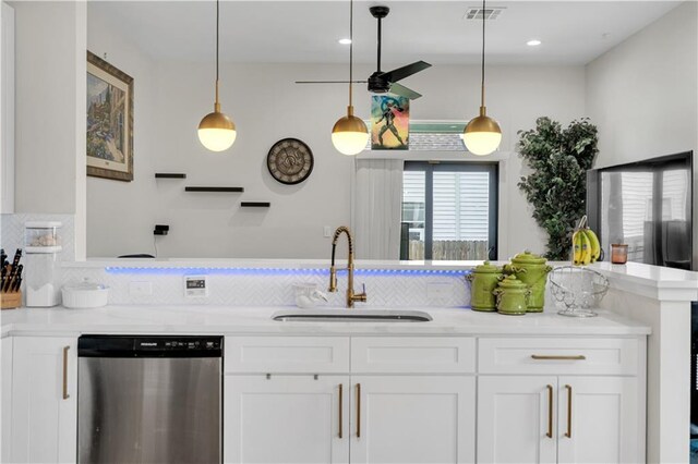 1039 Verret St, New Orleans, LA 70114 - kitchen with dishwasher, a sink, tasteful backsplash, white cabinets, and hanging light fixtures