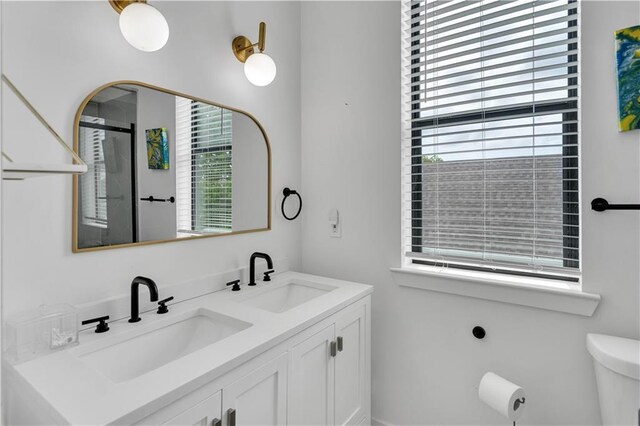 1039 Verret St, New Orleans, LA 70114 - bathroom featuring toilet, a shower stall, and double vanity