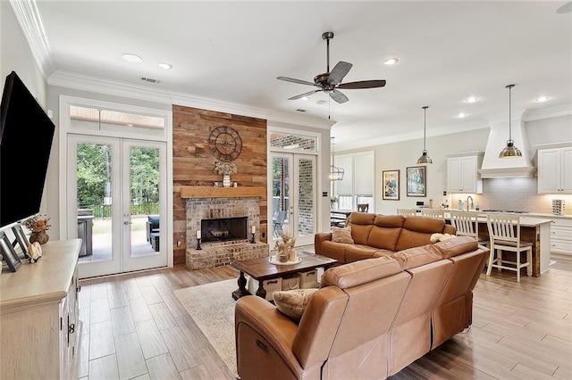 596 Blue Heron Ln, Madisonville, LA 70447 - living area featuring french doors, ceiling fan, recessed lighting, ornamental molding, and light wood-type flooring