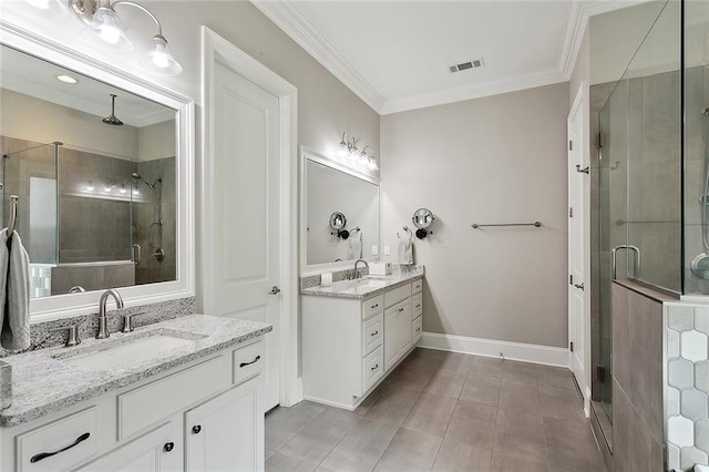 596 Blue Heron Ln, Madisonville, LA 70447 - bathroom featuring a shower stall, two vanities, crown molding, tile patterned flooring, and baseboards