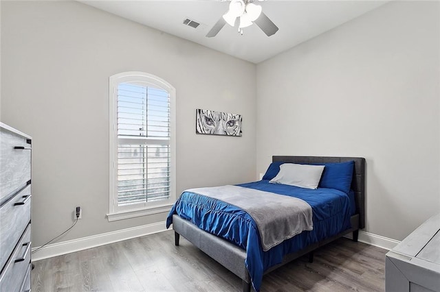 596 Blue Heron Ln, Madisonville, LA 70447 - bedroom with wood finished floors, baseboards, and ceiling fan