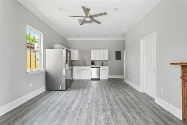 1827-29 Frenchmen St, New Orleans, LA 70116 - kitchen featuring appliances with stainless steel finishes, a ceiling fan, white cabinetry, crown molding, and light countertops
