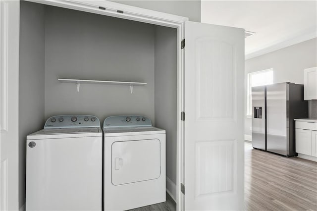 1827-29 Frenchmen St, New Orleans, LA 70116 - laundry room featuring separate washer and dryer and wood finished floors